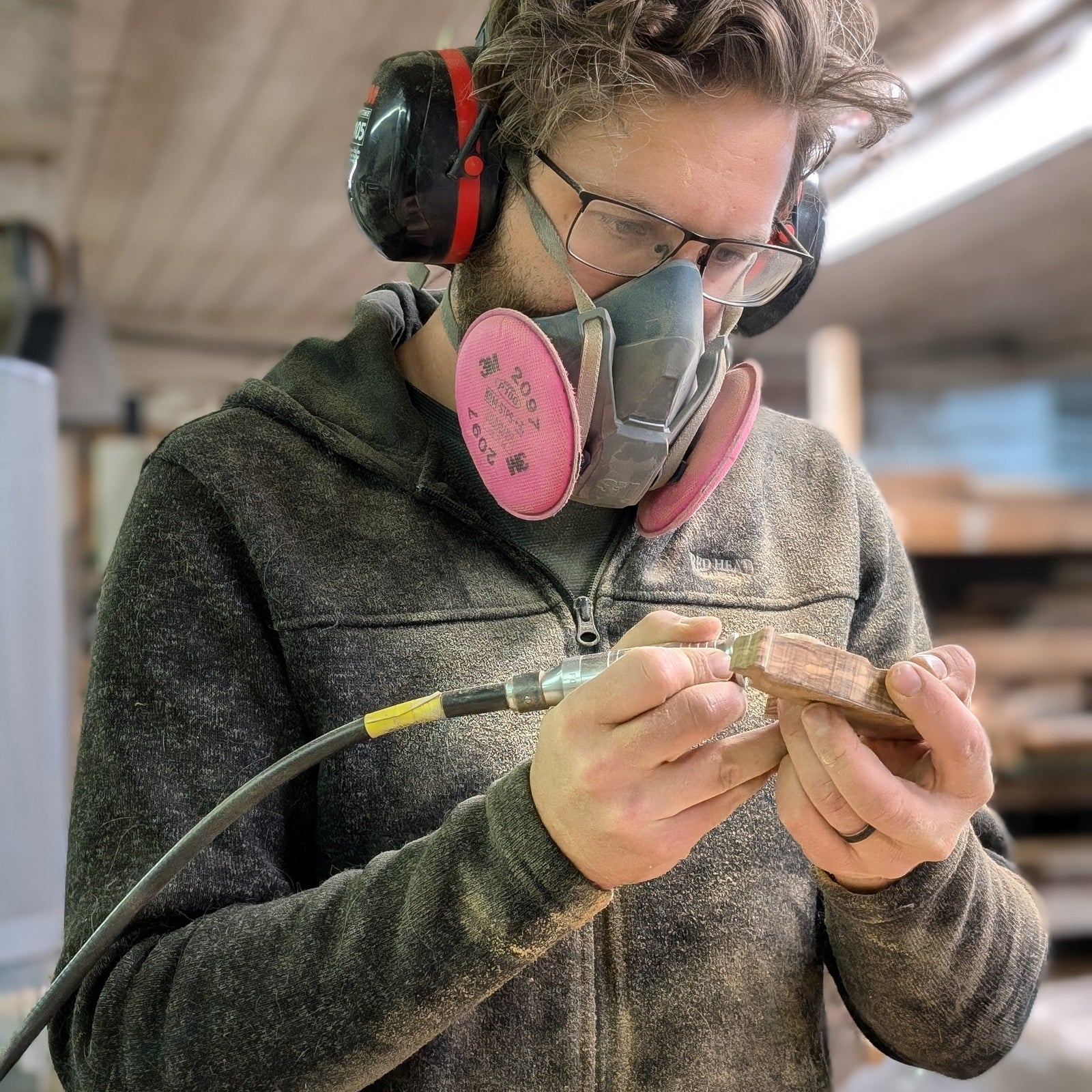 Alex Jepson carving a wood sculpture in his studio, showcasing expert craftsmanship and intricate wood carving techniques for nature-inspired art.
