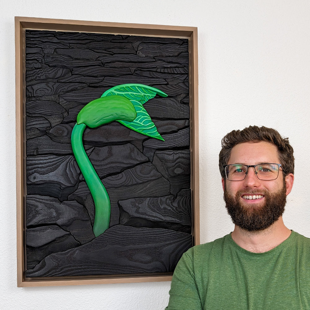  Alex Jepson standing beside Rebirth wood sculpture, showcasing luxury nature-inspired art, crafted with intricate wood carving techniques and fine details.