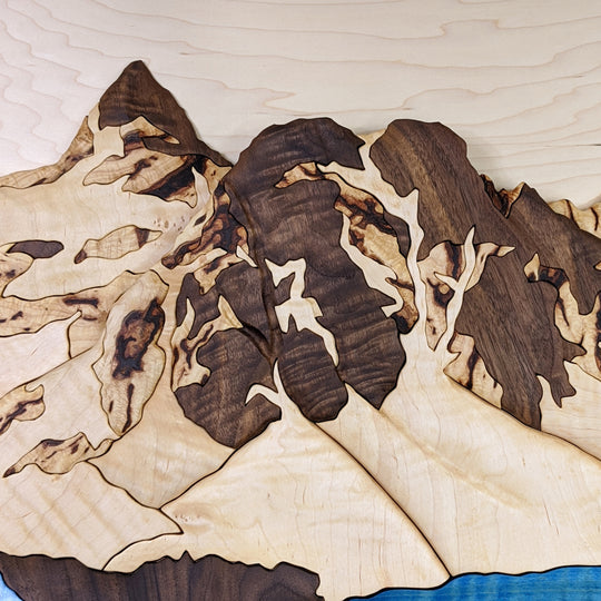 Close-up of Mount Assiniboine 3D wood sculpture by Alex Jepson, highlighting intricate textures and fine craftsmanship reflecting Banff’s rugged mountain beauty.
