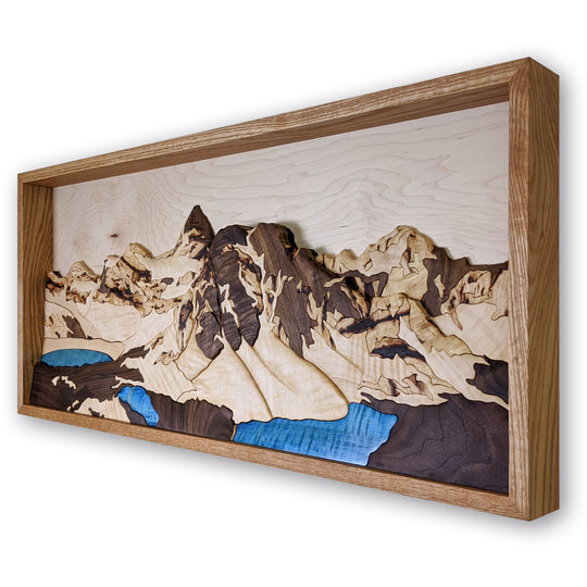 Side view of Mount Assiniboine 3D wood sculpture by Alex Jepson, showcasing fine craftsmanship and detailed depiction of Banff’s majestic mountain landscape.