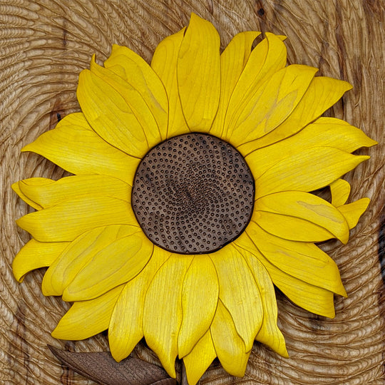 Close-up of Starry Night Sunflower wood sculpture by Alex Jepson, showcasing intricate carving details and vibrant textures in this nature-inspired artwork.