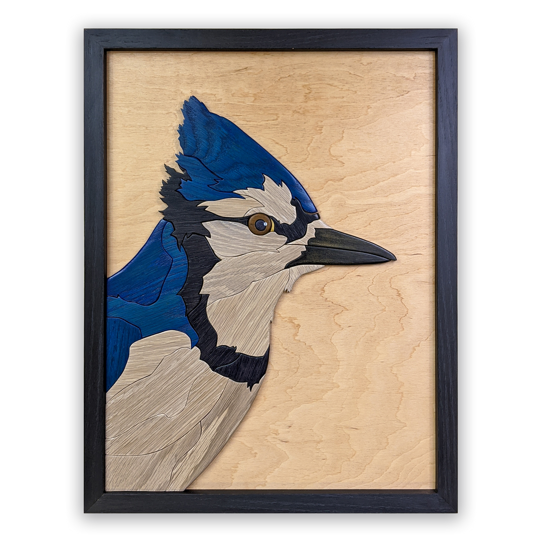 Full view of Watchful Blue Jay wood sculpture by Alex Jepson, showcasing intricate details and expert craftsmanship of the vibrant blue jay perched gracefully.